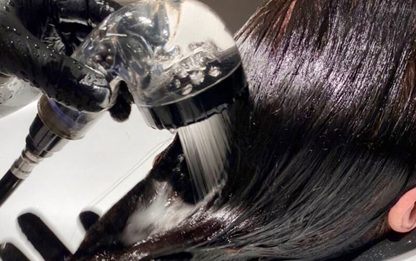 An eco shower-head in use at an Adore backwash